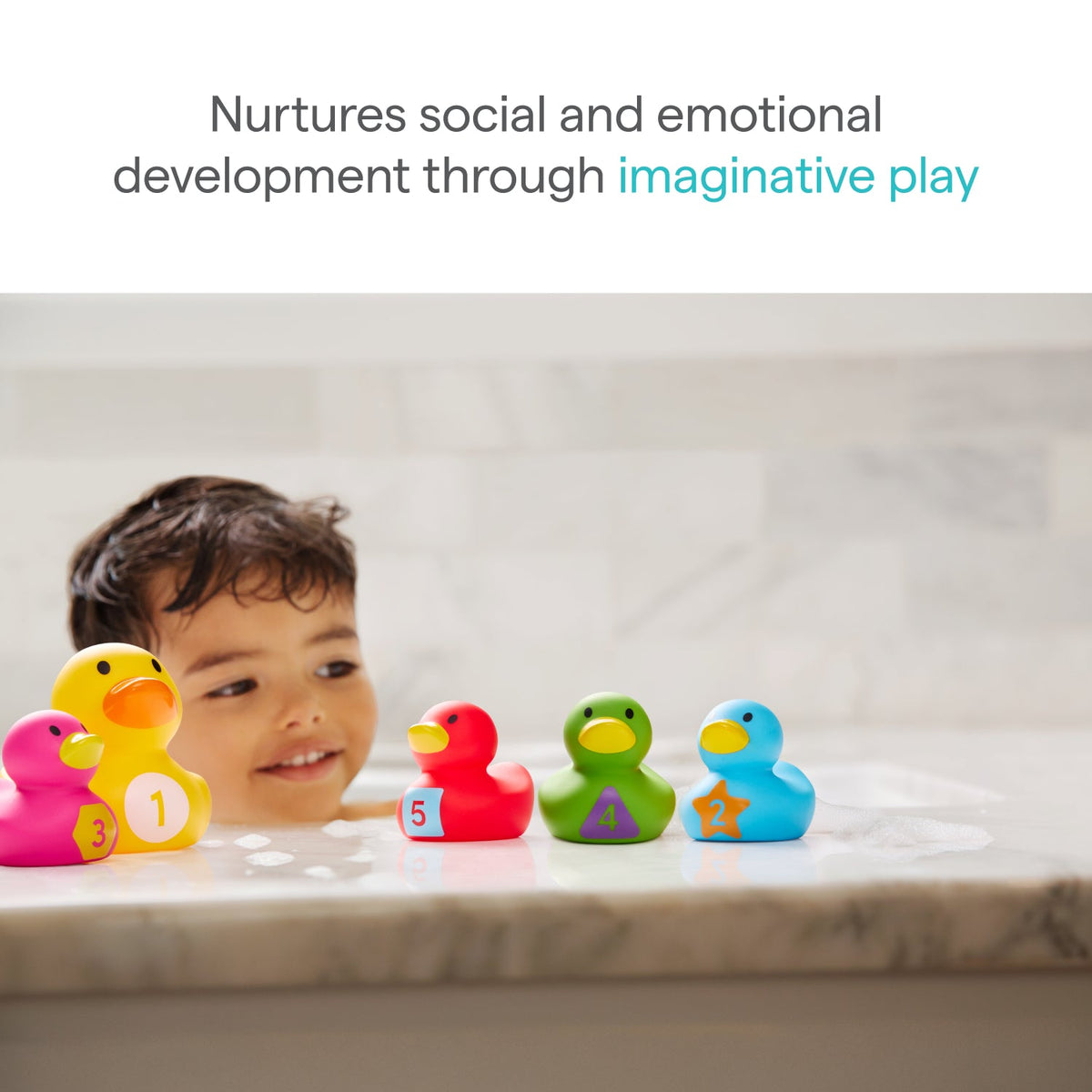 A young child smiles in the tub, playing with Munchkin Count Quack Bath Duckies—each a different color and numbered. Text reads, “Nurtures social and emotional development through imaginative play.”