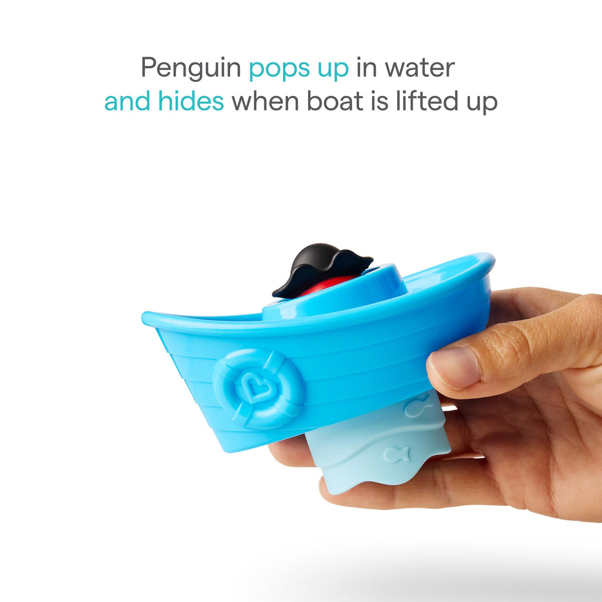 Blue toy boat with a penguin inside, held by a hand on a white background.