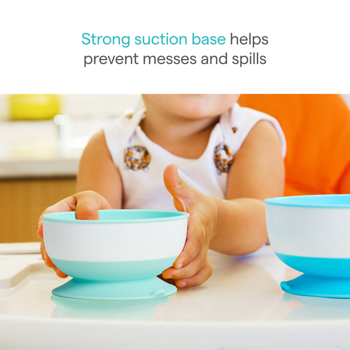 Child holding a blue and white bowl with a strong suction base, with text indicating its benefits.